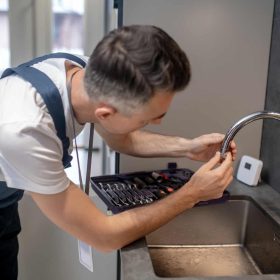 man-spinning-faucet-aerator-on-spout-pipe